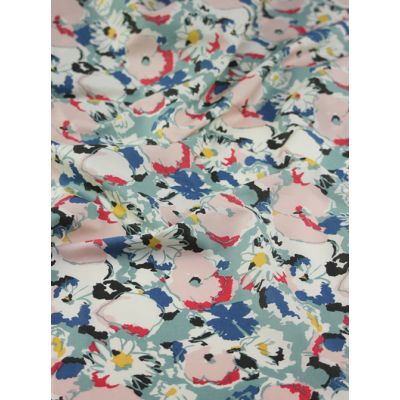 Abstract floral cotton fabric in soft pink, blue, and black tones with a sketch-style design.