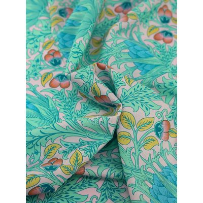 Close-up of Kaffe Fassett X William Morris Cotton Lawn Fabric – Indian Opera, featuring an intricate floral pattern in rich pink and red tones on finely woven cotton lawn.