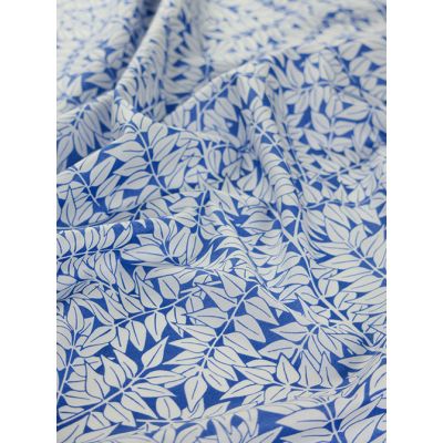 Close-up of Kaffe Fassett X William Morris Cotton Lawn Fabric – Branches Blue, featuring a delicate nature-inspired pattern in rich blue tones on finely woven cotton.