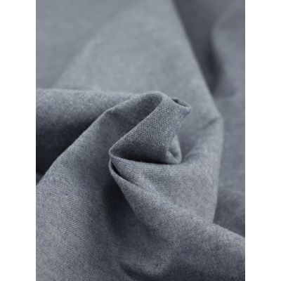 Close-up of Oxford Cotton Chambray fabric in indigo, showcasing its twill weave texture and denim-like blue and white thread mix.