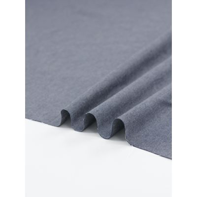 A richly textured Oxford Cotton Chambray fabric in indigo, featuring a classic twill weave with blue and white threads for a denim-like finish.