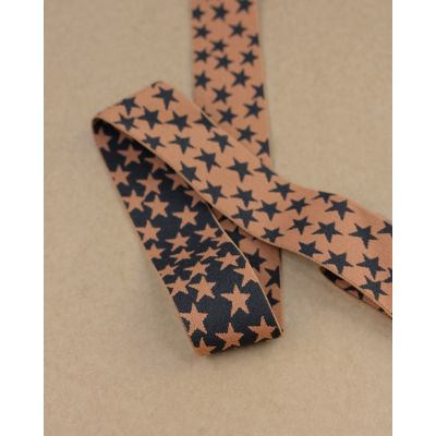 Reversible 40mm star elastic in black and caramel. Soft, stretchy and perfect for waistbands, trims and costume.